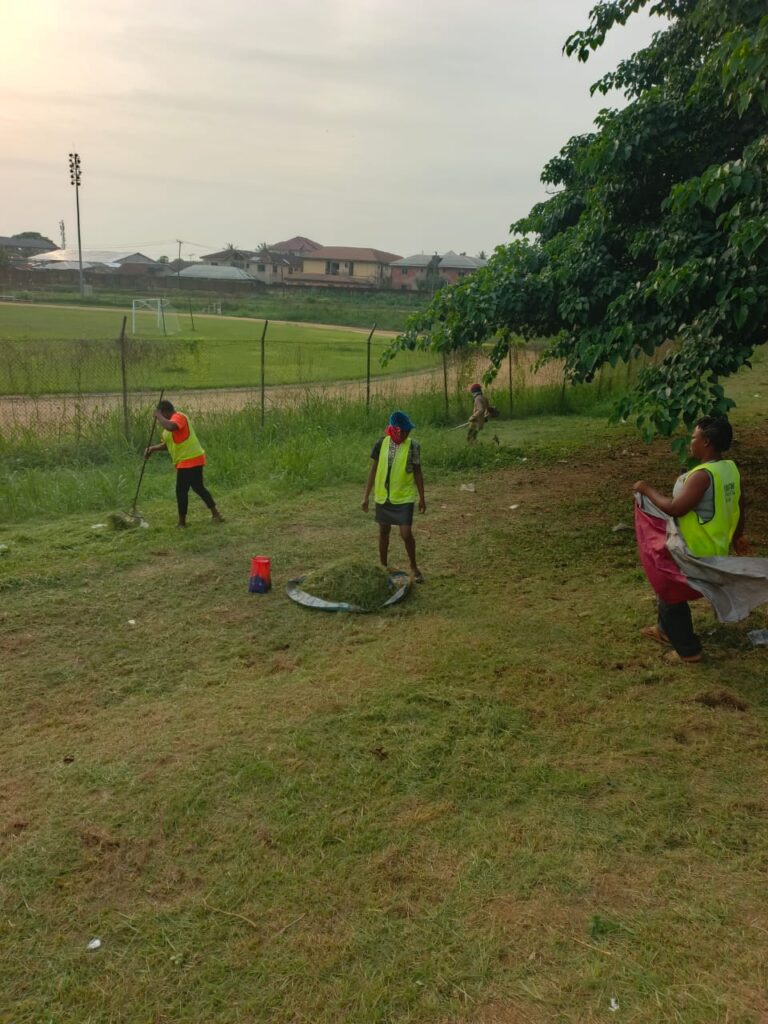 Landscape maintenance team working on a public roadside in Calabar.